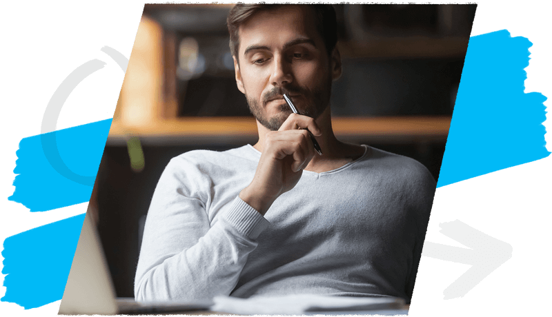 Man with pen pressed to lips considering options