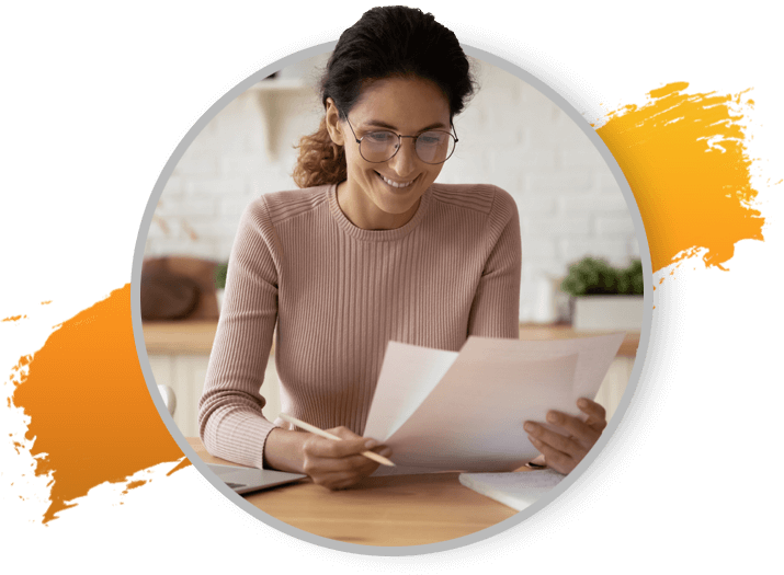 Smiling woman with glasses reading over documents